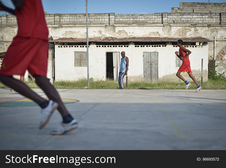 Basketball players run up the court, while their coach looks on, during a game in Mogadishu, Somalia, on June 6. Banned under the extremist group, Al Shabaab, Basketball is once again making a resurgence in Mogadishu. Today at least a dozen teams in the city play in a league and both men and women are coming out to play the sport. AU UN IST PHOTO / TOBIN JONES. Basketball players run up the court, while their coach looks on, during a game in Mogadishu, Somalia, on June 6. Banned under the extremist group, Al Shabaab, Basketball is once again making a resurgence in Mogadishu. Today at least a dozen teams in the city play in a league and both men and women are coming out to play the sport. AU UN IST PHOTO / TOBIN JONES
