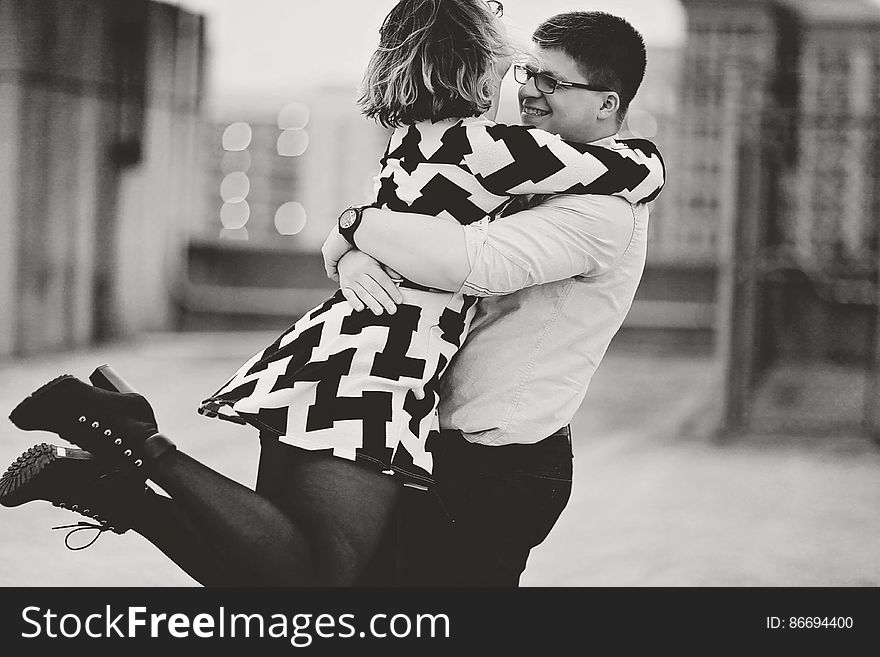 Rear View Of Couple Walking In City