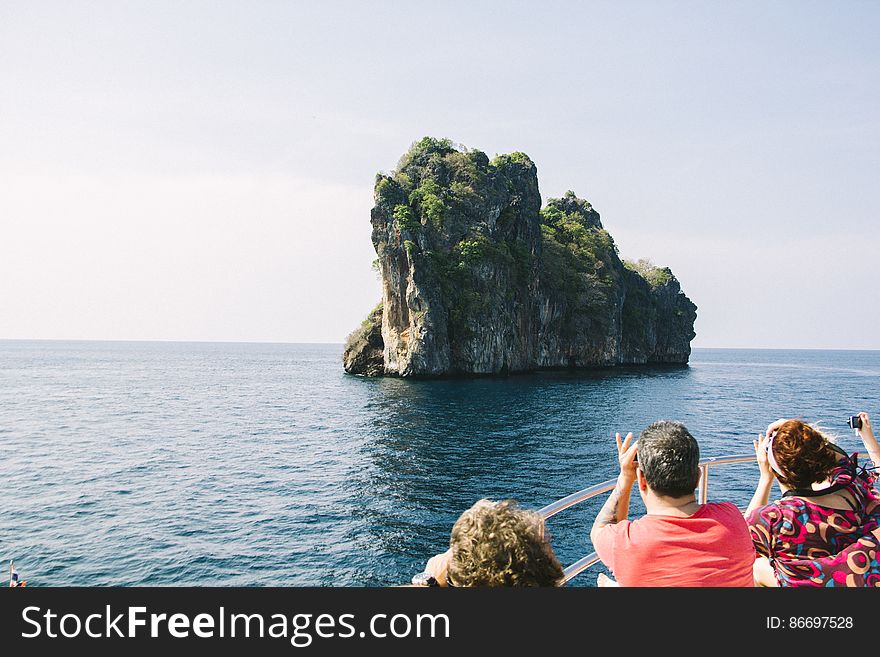 People On Rock By Sea