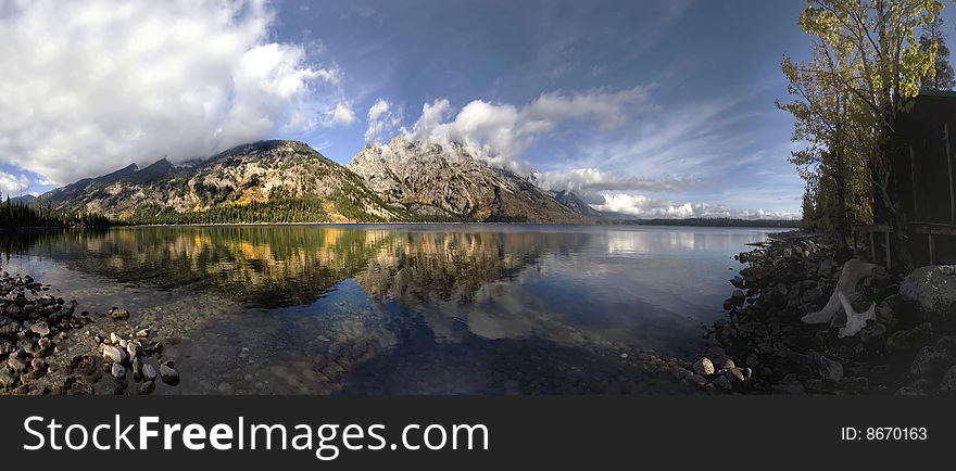 The Grand Teton Mountains reflected in the calm waters of Jenny Lake, Wyoming.