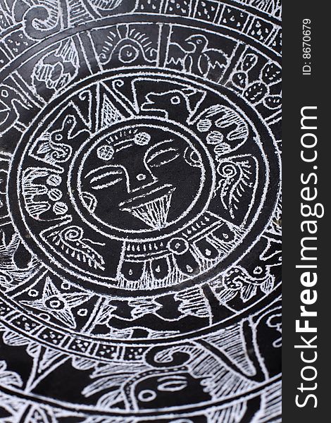 A close up of an Aztec calendar.