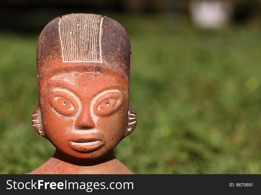 A clay, carved south American statue.