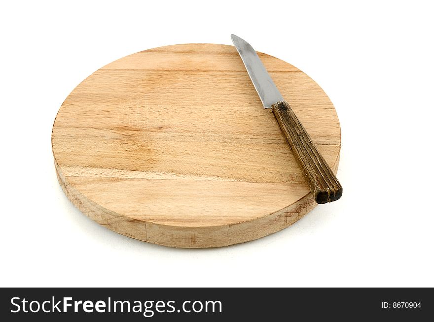 Round chopping board and knife on white background