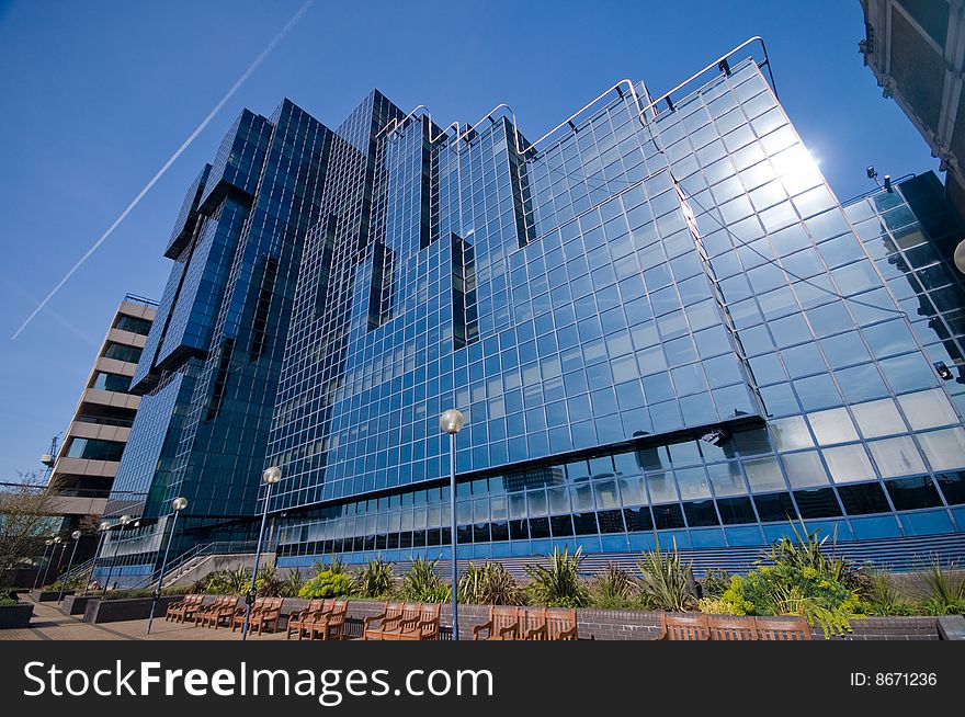 Shiny Glass Office Building Against Blue Sky