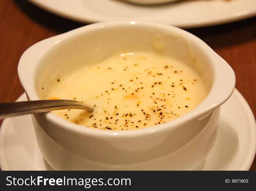 Cream of mushroom soup with a spoon placed on the table