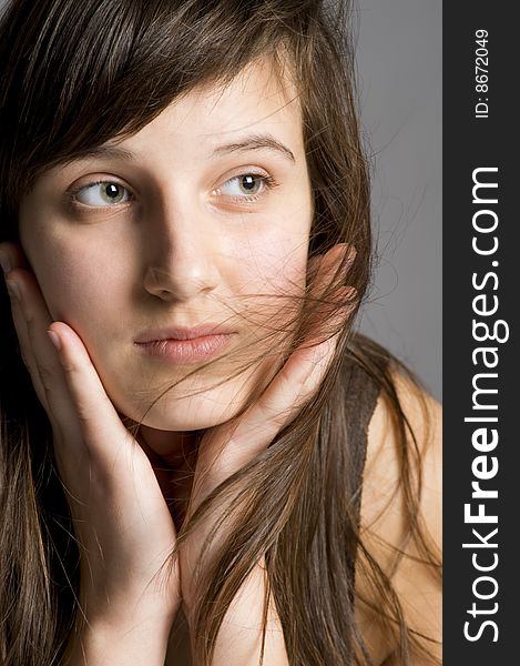 Thoughtful teenager with the dispersed hair portrait