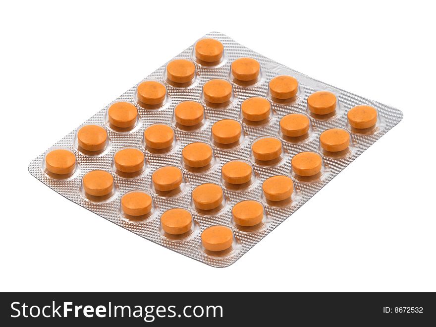 Orange tablets in the blister pack isolated over white