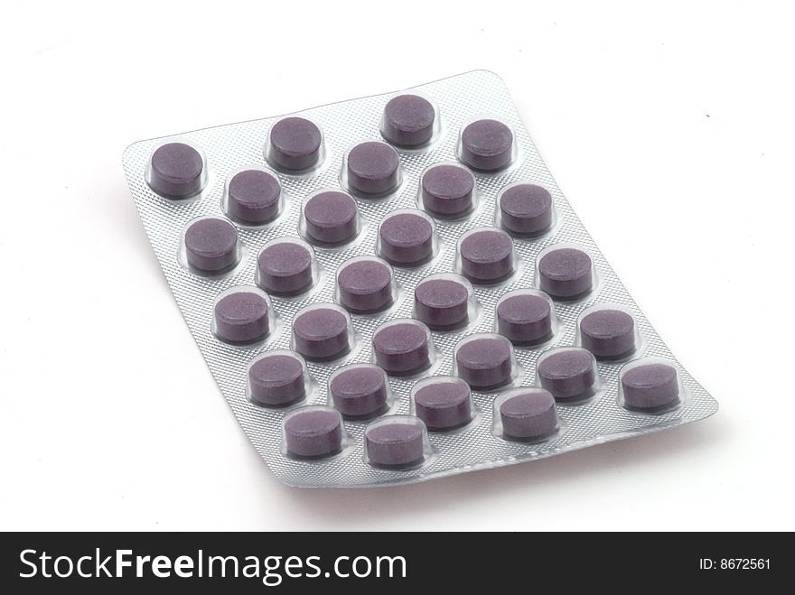 Violet tablets in the blister pack