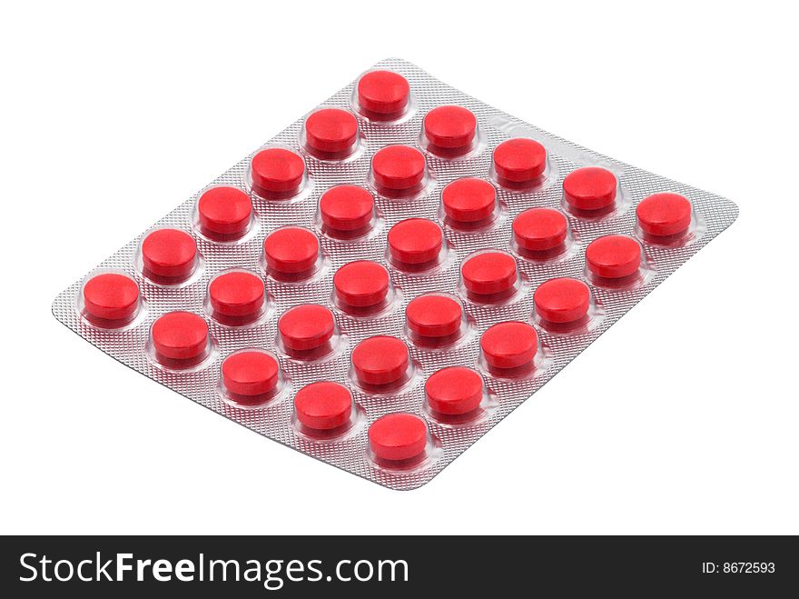 Red tablets in the blister pack isolated over white