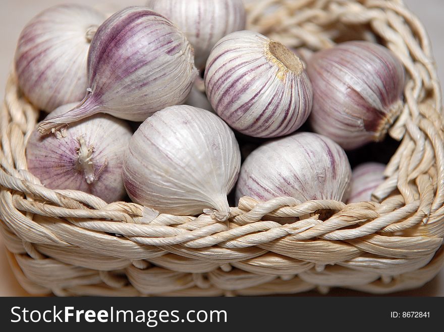 The Chinese garlic in a straw basket. The Chinese garlic in a straw basket
