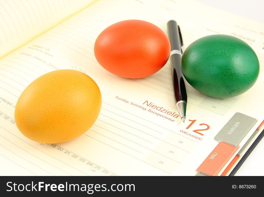Colored, eggs, and business calendar plus calculator, pen and chart,. Colored, eggs, and business calendar plus calculator, pen and chart,