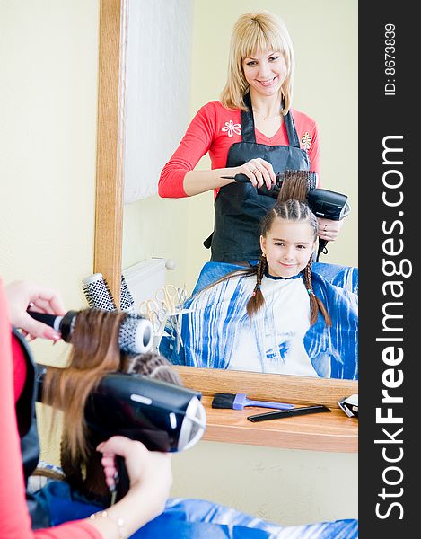 Little girl in hairdresser salon