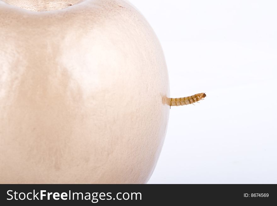 Golden apple and worm on white background