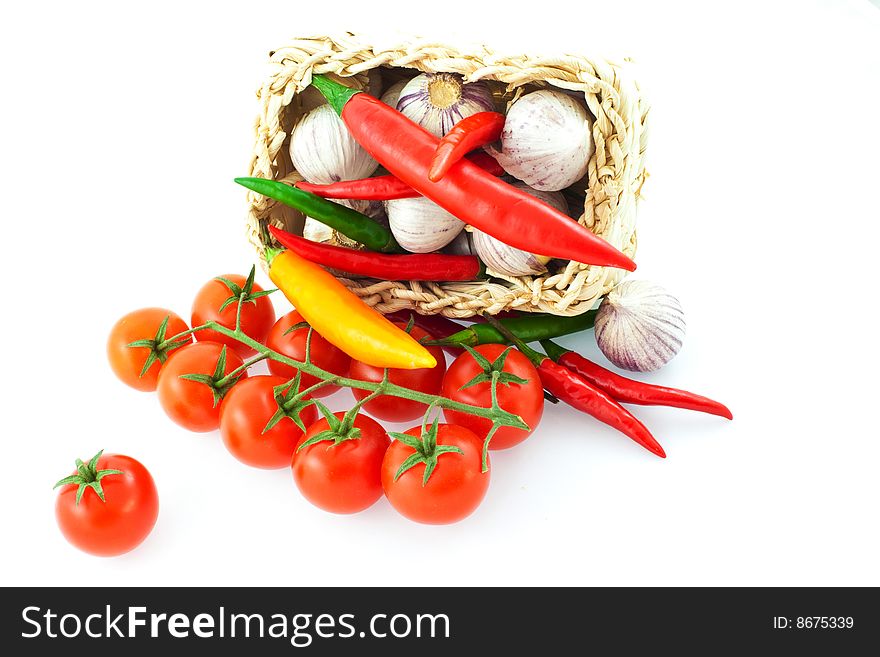 Tomatoes, pepper and garlic in a basket. Tomatoes, pepper and garlic in a basket