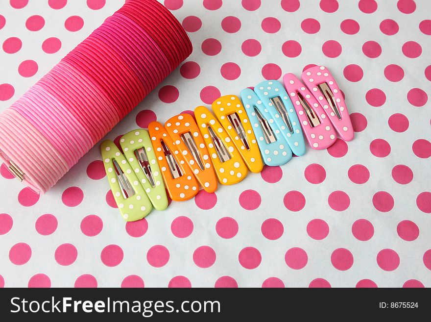 Variation of Pink Hairbands and clips on pink polka-dot background