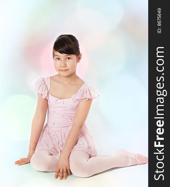 Young ballerina girl on pink dress