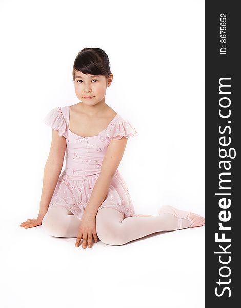 Young ballerina girl on pink dress