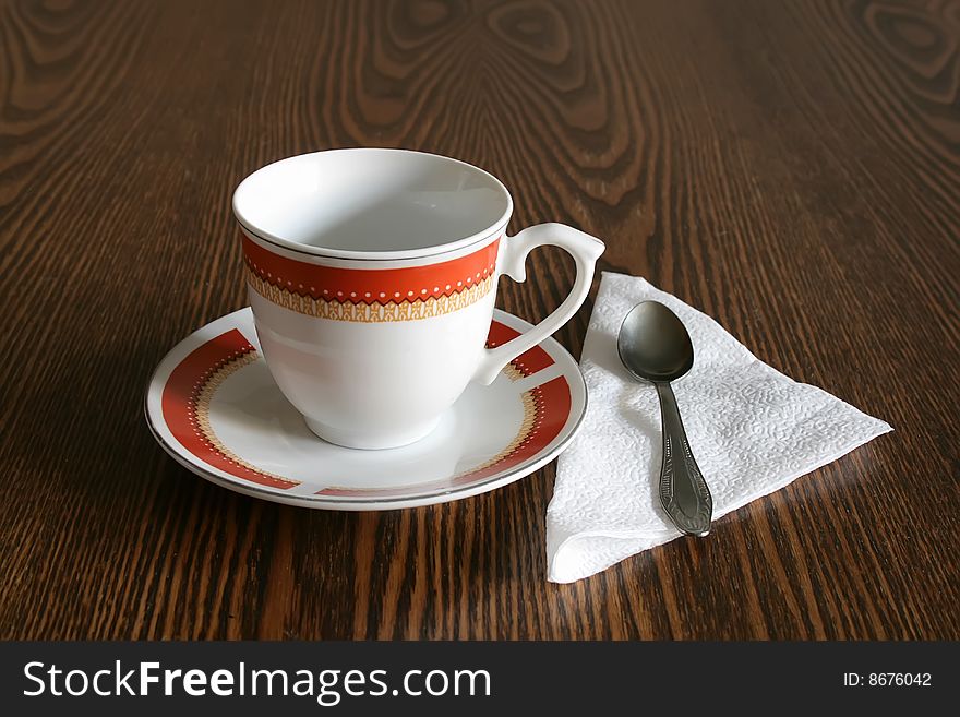 Coffee cup with a saucer on a wooden table