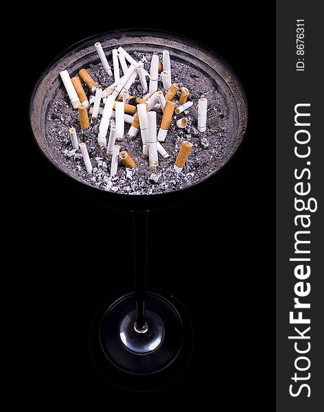 Some cigarettes in ashtray on isolated black background