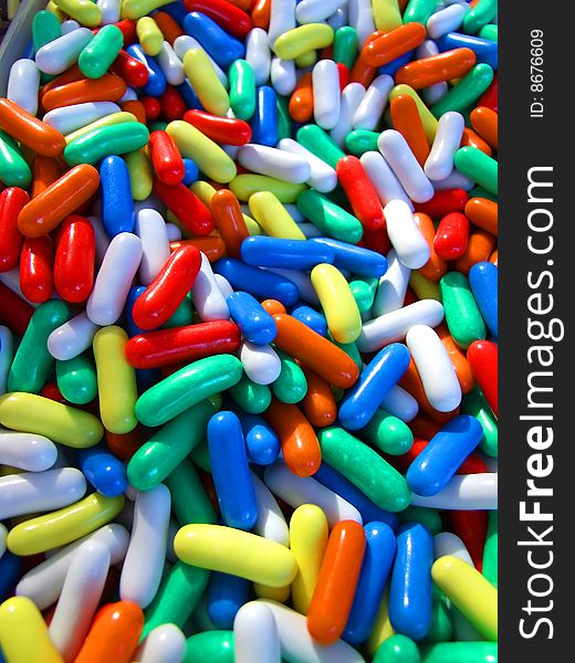 Pills or sweets in blue, white, red, yellow, orange and green