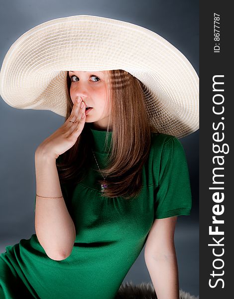 Funny young cutey in a green dress with a big straw hat. Funny young cutey in a green dress with a big straw hat