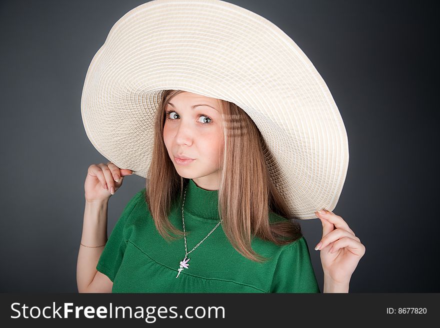 Funny young cutey in a green dress with a big straw hat. Funny young cutey in a green dress with a big straw hat