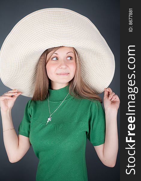 Funny young cutey in a green dress with a big straw hat. Funny young cutey in a green dress with a big straw hat