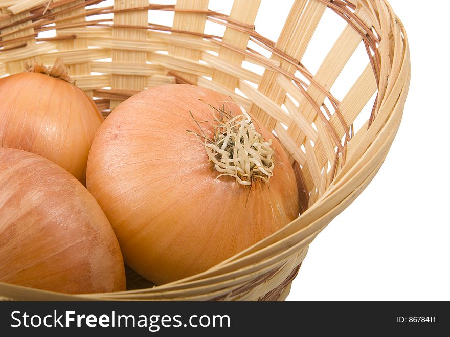 There are same onions in the basket on the white background. There are same onions in the basket on the white background