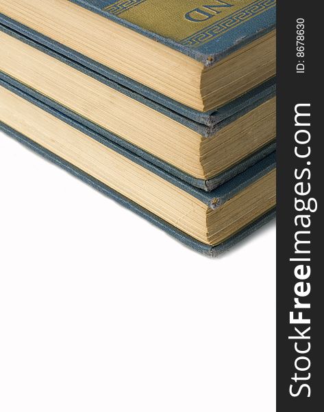 Text books stacked up on a white background