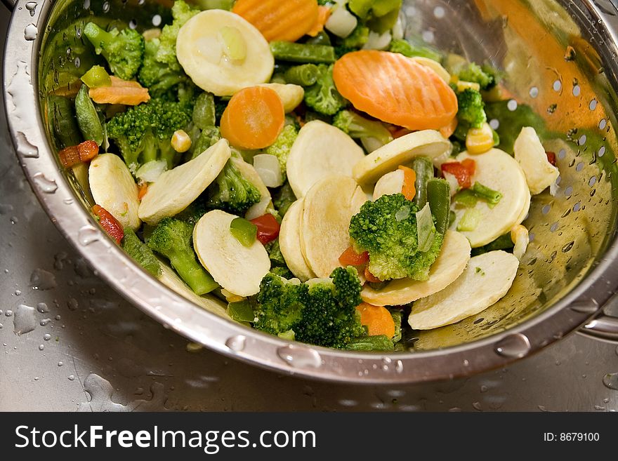 Close-up of fresh vegetables in silver strainer