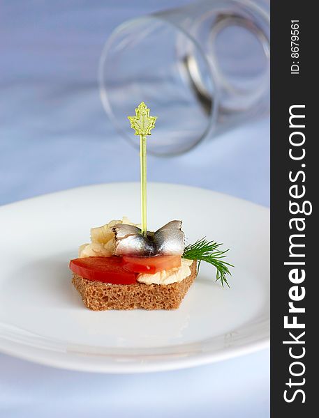 Table for a buffet. Canape with vegetables and herring
