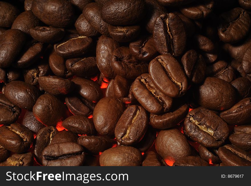 Closeup of coffee beans with red highlight. Closeup of coffee beans with red highlight