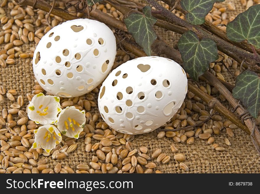 Easter egg against a background from jute and corn.