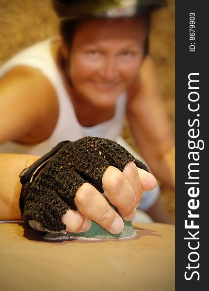 Senior woman working out on a rock climbing wall. Senior woman working out on a rock climbing wall