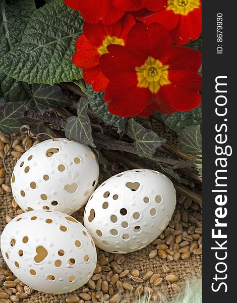Easter decoration with primrose,Easter egg against a background from corn.