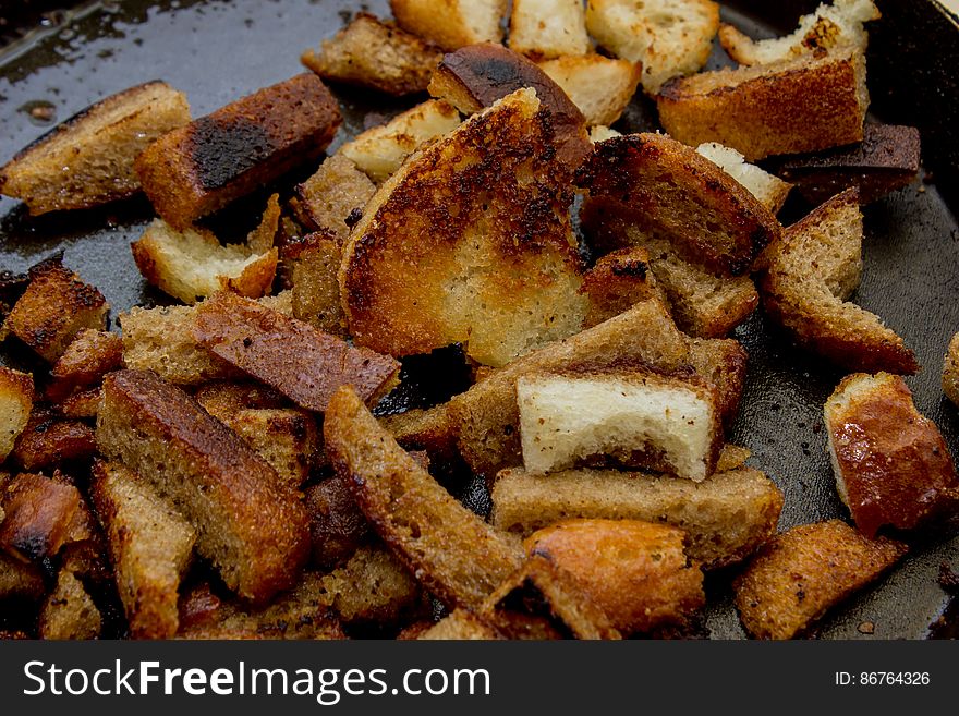 Croutons , croutons, lying on a black background ,on a cutting Board. Croutons , croutons, lying on a black background ,on a cutting Board