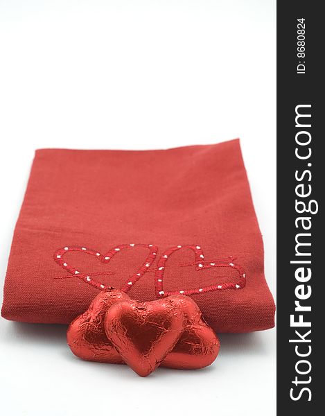 Red heart blanket with heart shaped chocolates. Red heart blanket with heart shaped chocolates
