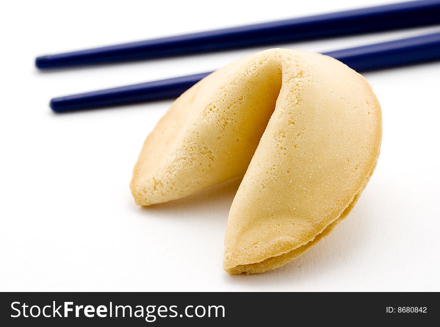 Fortune cookie and blue chopsticks