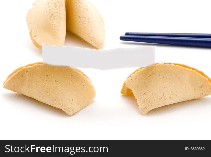 Opened fortune cookie with blank fortuneOpened fortune cookie with blue chopsticks in background. Opened fortune cookie with blank fortuneOpened fortune cookie with blue chopsticks in background