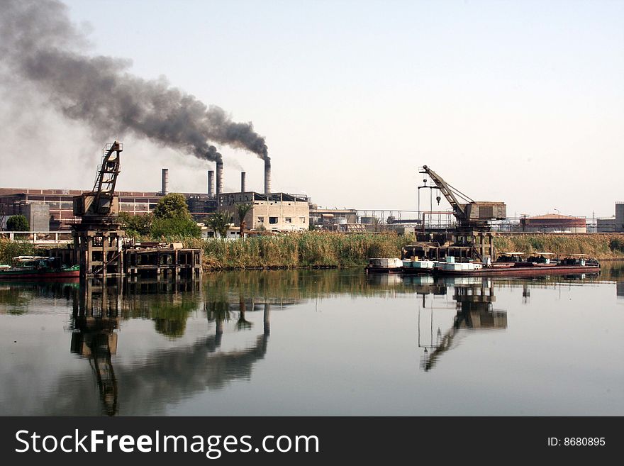 This is an image of a refinery along a river. This is an image of a refinery along a river.