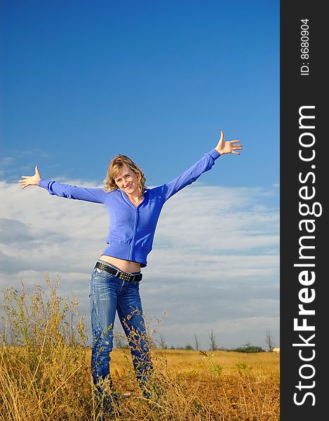 The girl in an autumn field against the sky. The girl in an autumn field against the sky