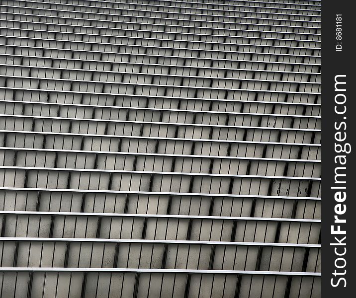 Tiers of Grey and Silver Grooved Metal Corrugation for Building Side