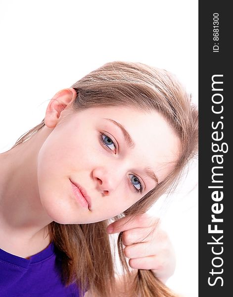 Studio Shot of a beautiful girl in a blue t-shirt dressing her hair, isolated on white background. Studio Shot of a beautiful girl in a blue t-shirt dressing her hair, isolated on white background