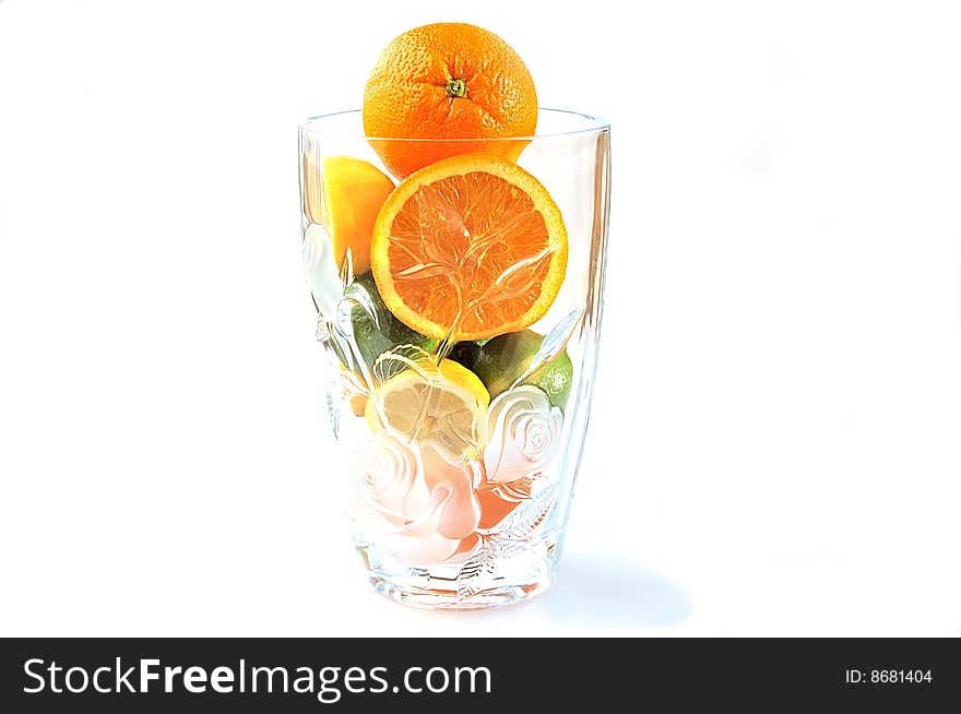 Oranges, lemons and limes in the big glass vase.