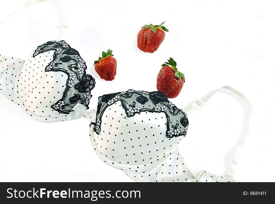 Silk bra and strawberry on white background with clipping path. Silk bra and strawberry on white background with clipping path.