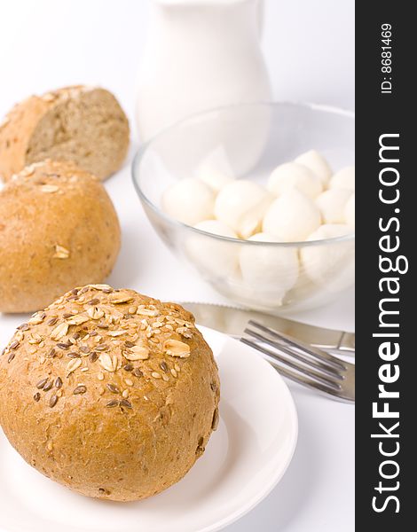 Bread, milk and mozzarella closeup on white