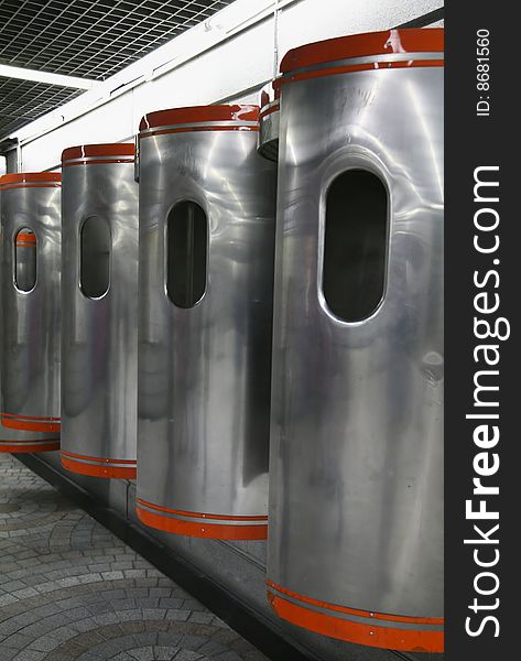 Orange and Silver Metal Public Phone Booths in Subway