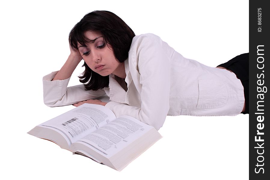 Young business woman laying on the floor and reading a book. Young business woman laying on the floor and reading a book