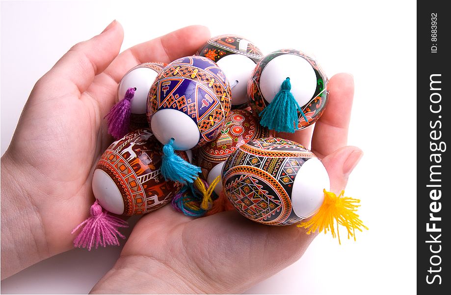 Colorful Easter eggs in palms, isolated on white background. Colorful Easter eggs in palms, isolated on white background.