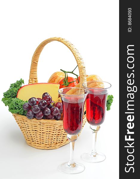 Red wine and a basket filled with bread and cheese. Red wine and a basket filled with bread and cheese.